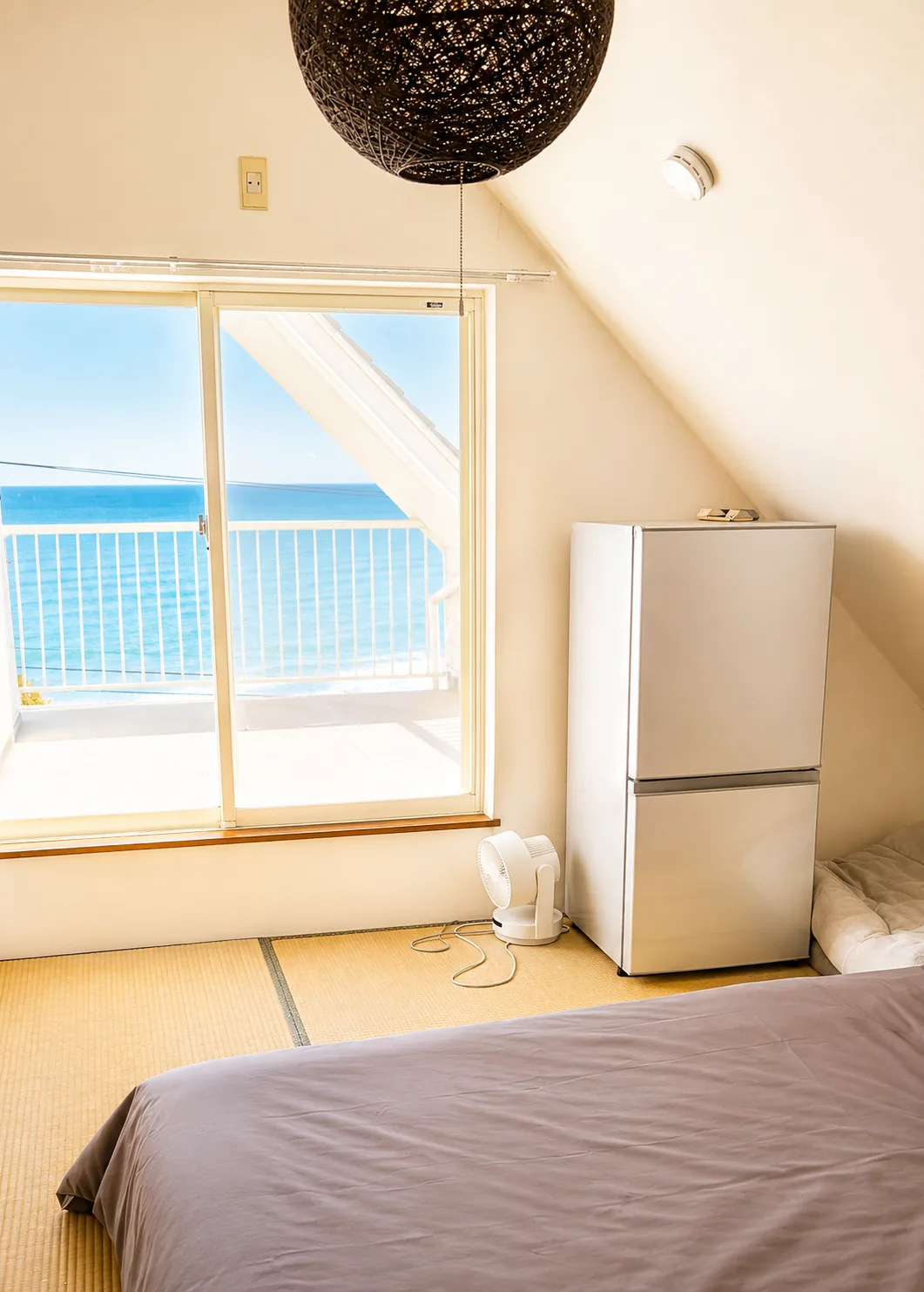 Loft bedroom overlooking the ocean — private beach house near Tokyo