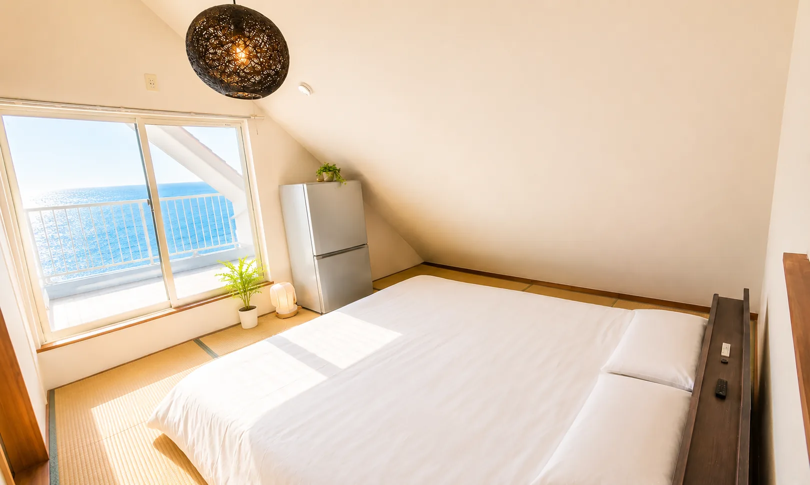 Tatami loft bedroom with Pacific Ocean view — SORA Blue House