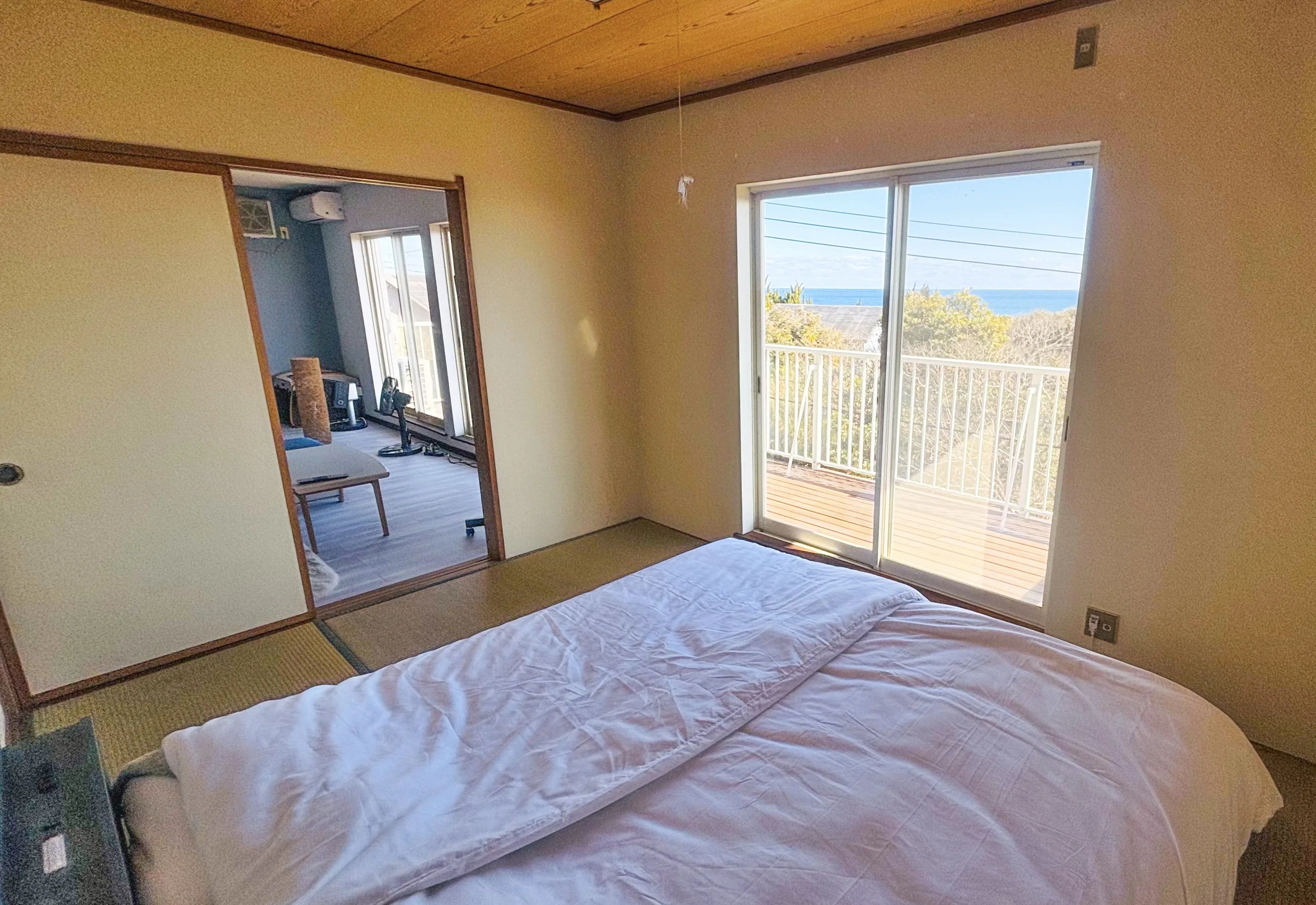 Tatami bedroom with balcony and ocean view — SORA Blue House