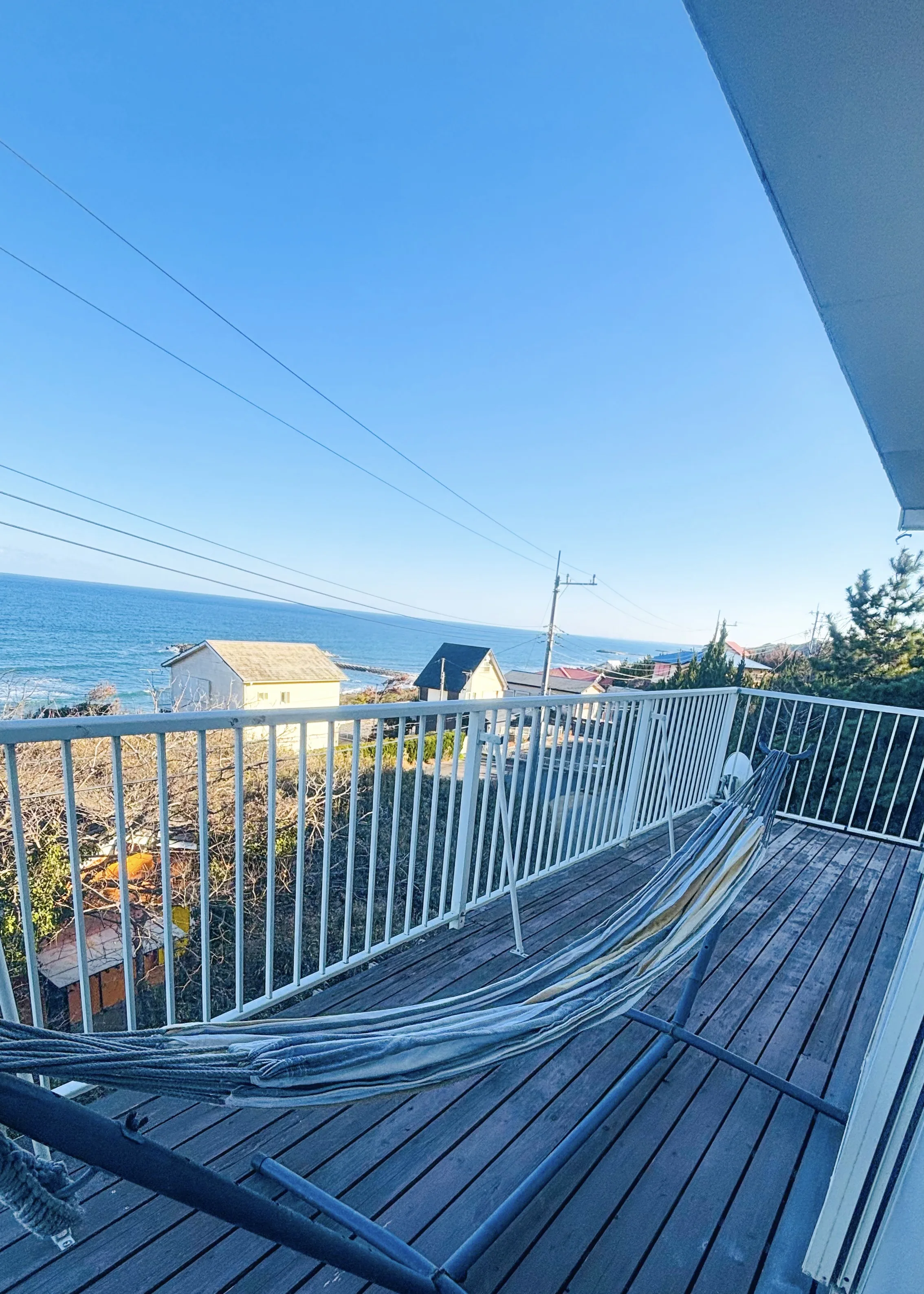 Owner Shiori at the terrace — SORA Blue House private beach house Japan