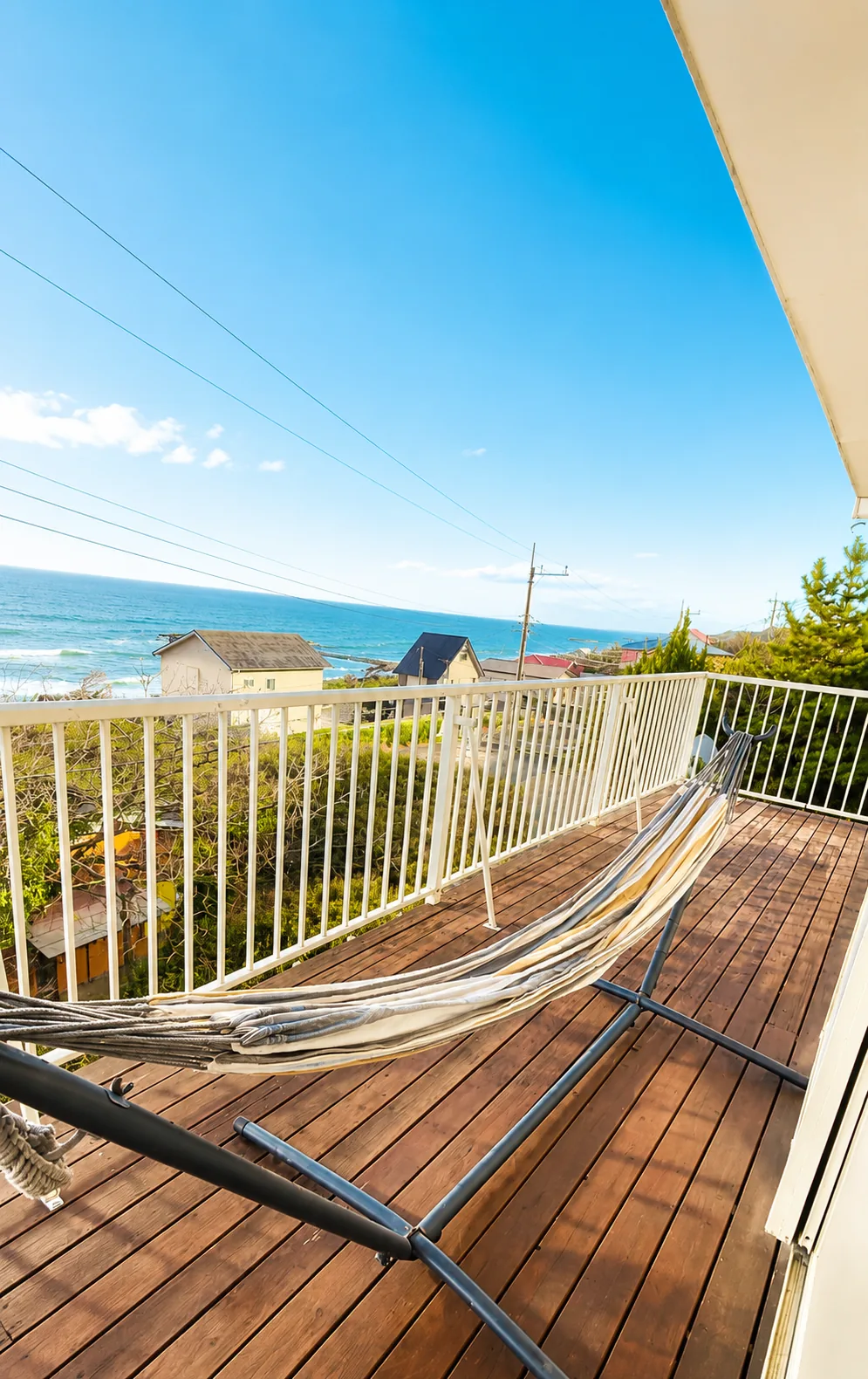 Ocean-view balcony with hammock — SORA Blue House beach house Japan